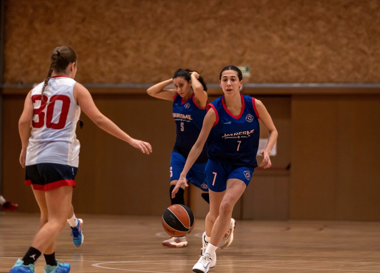 Jugadora del CB 3 Viles botant la pilota durant un partit